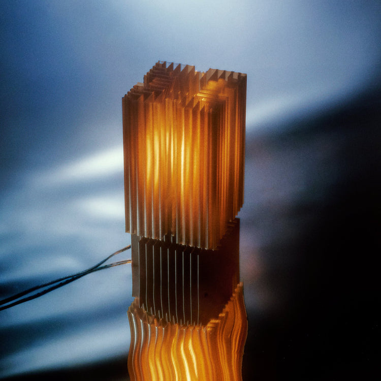3D printed Brut Lamp by Wooj Design, showcasing a modern, angular design inspired by brutalist architecture in a smoky finish.