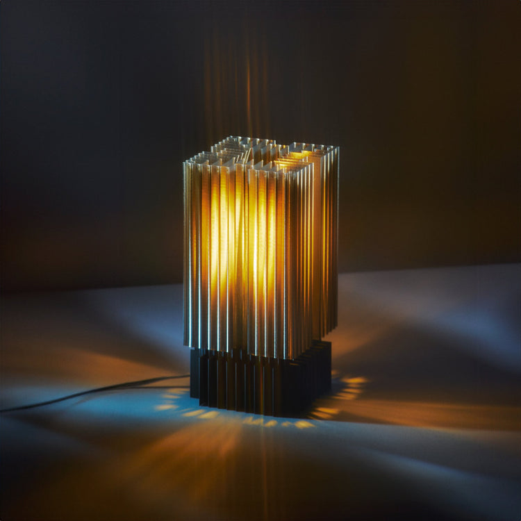 3D printed Brut Lamp by Wooj Design showcasing brutalist architecture in a smoky, textured design.