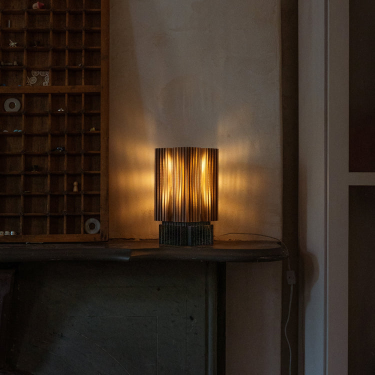 Wooj Design Brut Lamp, a 3D printed sculpture inspired by brutalist architecture with a smoky gray finish.