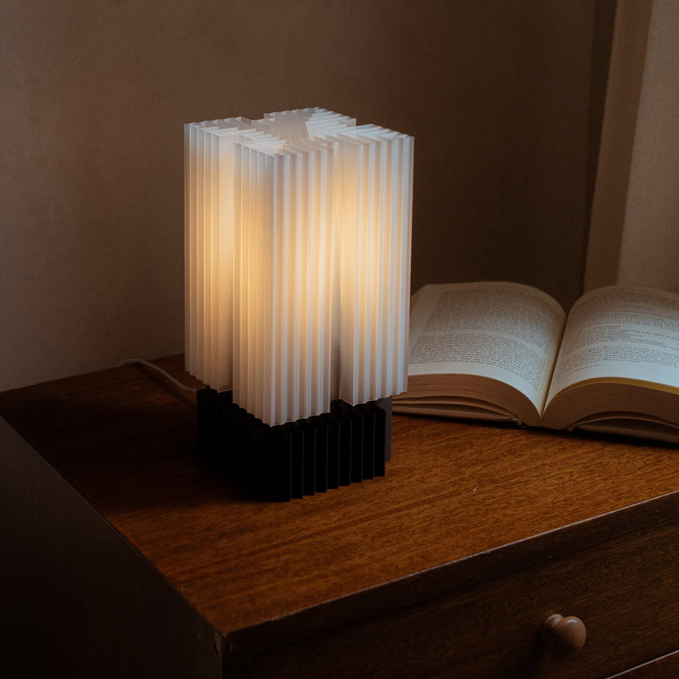 Wooj Design Brut Lamp, a 3D printed sculpture inspired by brutalist architecture with a smoky finish