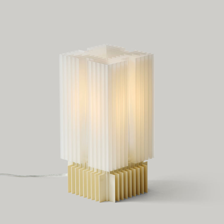 Wooj Design Brut Lamp, a 3D printed sculpture inspired by brutalist architecture, featuring a textured, geometric concrete-like finish.