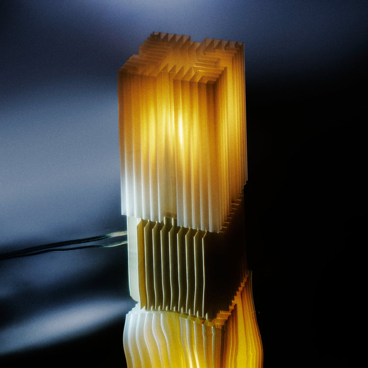Wooj Design Brut Lamp: 3D printed sculpture inspired by brutalist architecture with a smoky finish, showcasing modern architectural design.