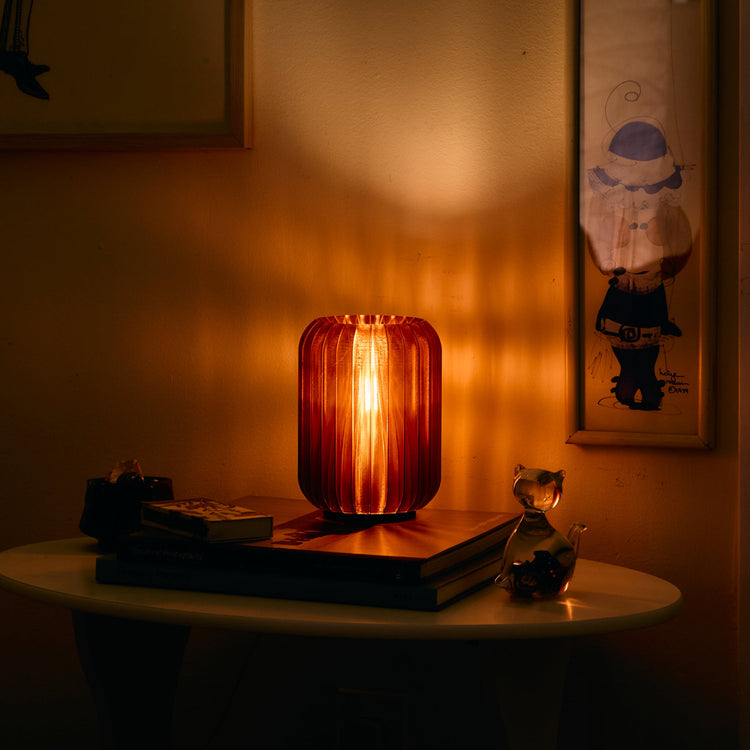 Modern cordless Allium table lamp by Wooj Design, rechargeable mini accent light with smoke-colored finish, ideal for stylish lighting.