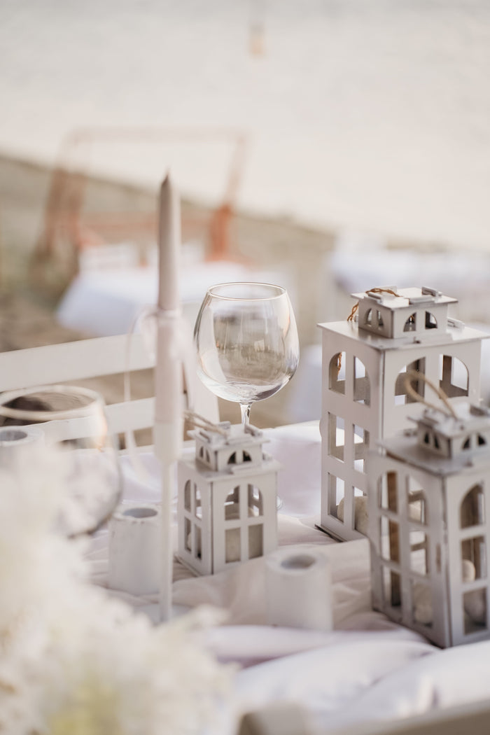 candle lanterns in graduated sizes on extravagant table