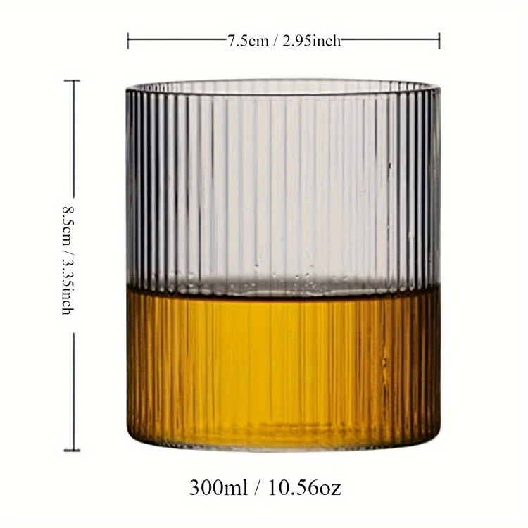 Glass tumbler with ribbed design filled with a yellow liquid, showing measurements on a white background.