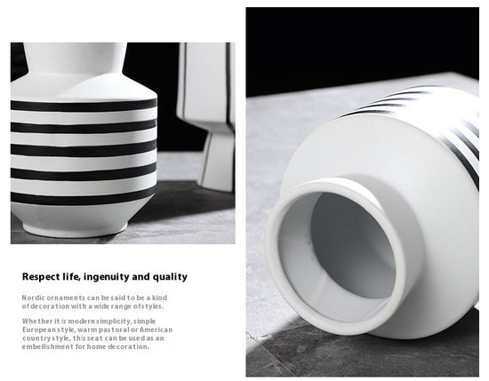 Black and white striped ceramic vase with a light, modern design suitable for contemporary home decor.