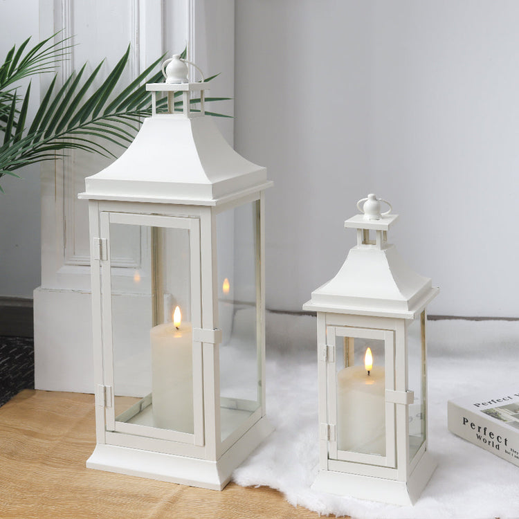 Set of 2 JHY DESIGN outdoor decorative candle lanterns, 19.5 and 13 inches tall, with glass panels and metal frames.