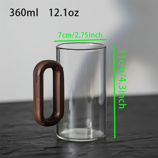 Clear glass mug with wooden handle and measurements on a gray background