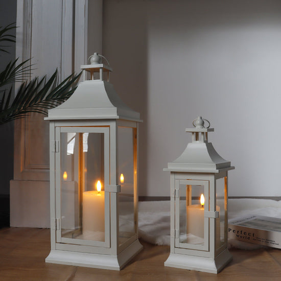 Set of two JHY DESIGN outdoor decorative candle lanterns, 19.5 and 13 inches tall with glass panels and metal frames.
