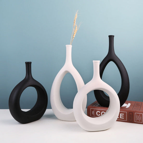Modern ceramic vase by FLIPSTYLEZLLC with a unique shape, filled with fresh flower arrangement, ideal for elegant home decor.