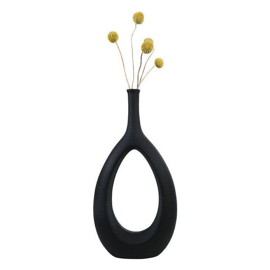 Simple ceramic vase with flower arrangement, modern home decor by FLIPSTYLEZLLC, featuring elegant shapes and a luxurious finish.