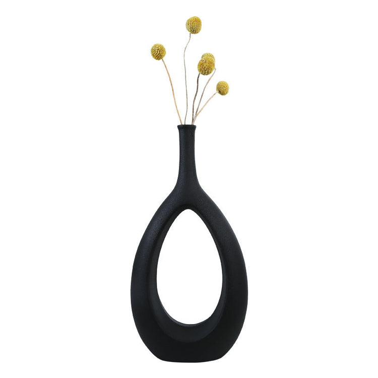 Simple ceramic vase with flower arrangement, modern home decor by FLIPSTYLEZLLC, featuring elegant shapes and a luxurious finish.