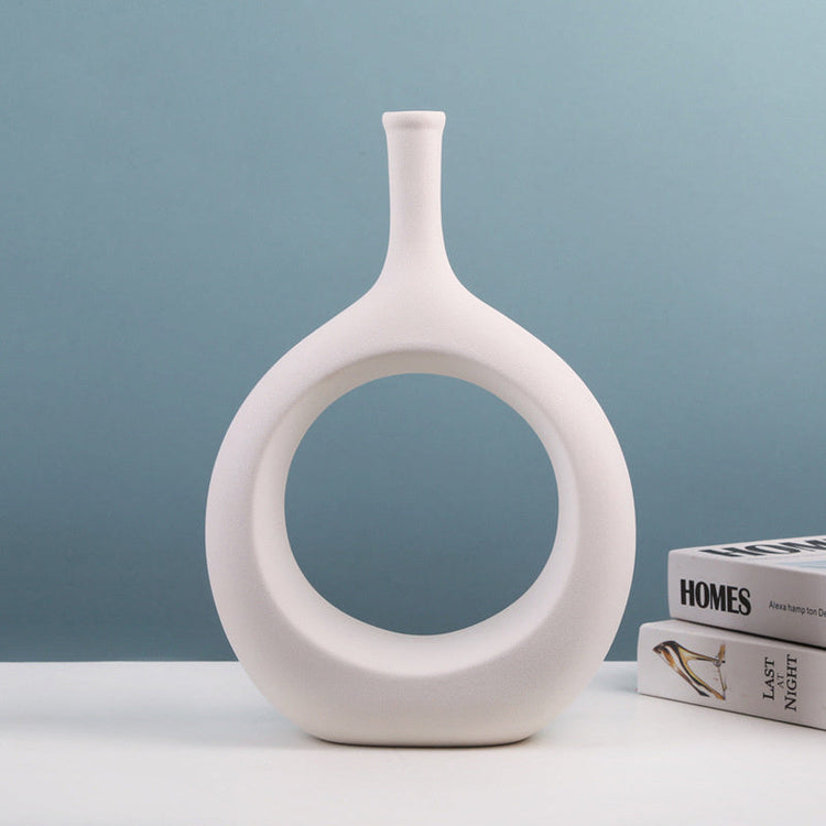 Modern ceramic vase with unique shapes from FLIPSTYLEZLLC, holding a flower arrangement for elegant home decor.