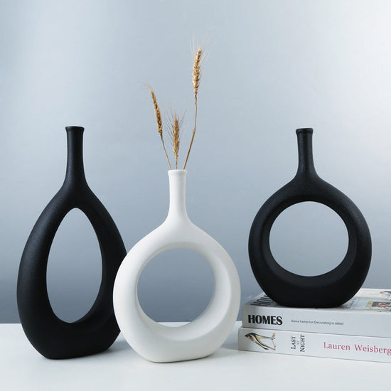 Elegant ceramic vase with a unique shape holding a floral arrangement, perfect for modern home decor by FLIPSTYLEZLLC