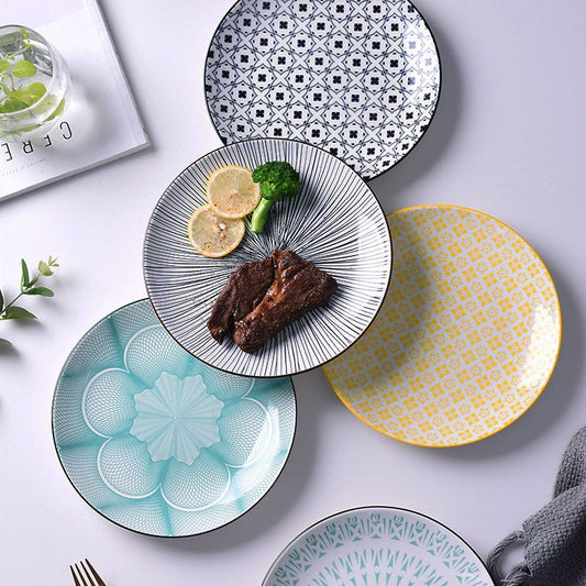Set of patterned ceramic plates on a light gray background
