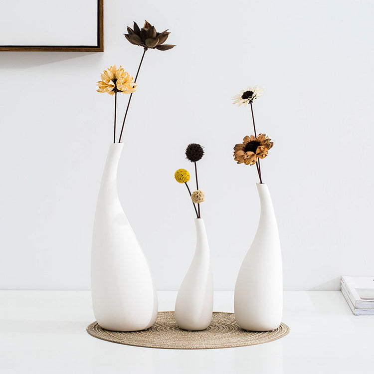 White ceramic water drop vase with modern design, suitable for dried flowers and floral ornaments in a contemporary room setting.