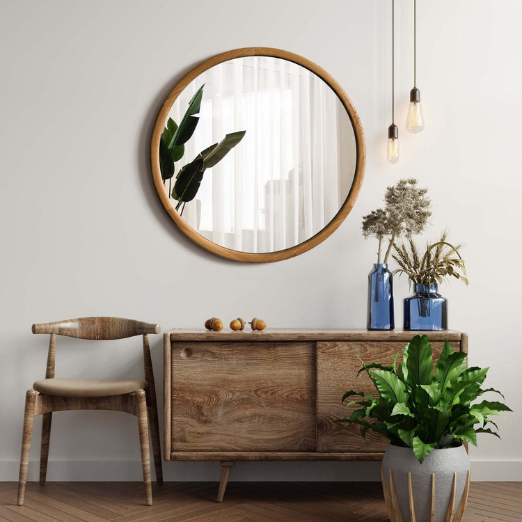 VARBROS THE KOLO wall mirror with a sleek round design and minimalist frame hanging on a modern interior wall.