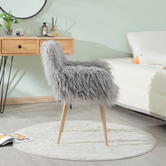 Grey faux fur upholstered dining chair with metal legs, modern and comfortable seating for dining rooms.