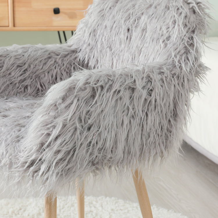 Grey faux fur upholstered dining chair with sleek metal legs, modern and comfortable for stylish dining room decor.