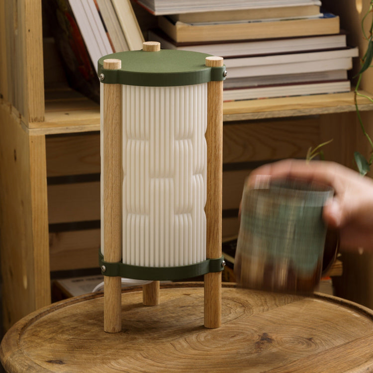 Terra Labs Toro table lamp with a sleek modern design and a cylindrical base, illuminated on a contemporary side table.