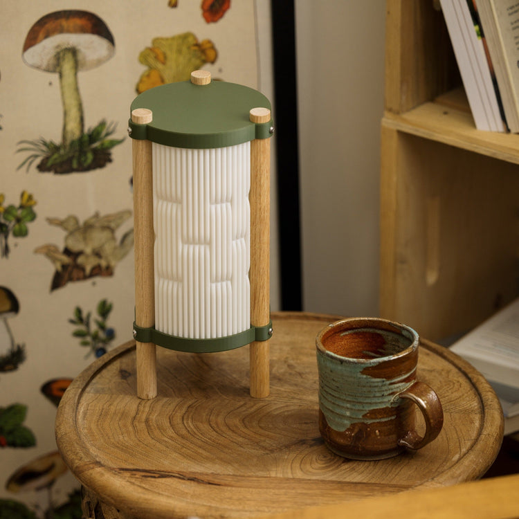 Terra Labs Toro table lamp with modern design, featuring a sleek base and a cylindrical lampshade in a well-lit setting.