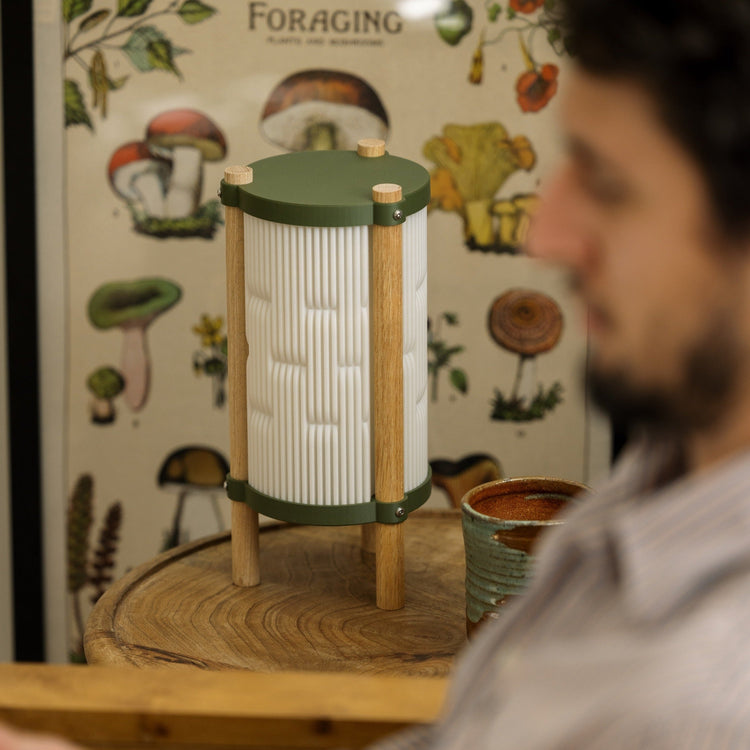 Terra Labs Toro table lamp with a sleek modern design, featuring a cylindrical base and a fabric lampshade.
