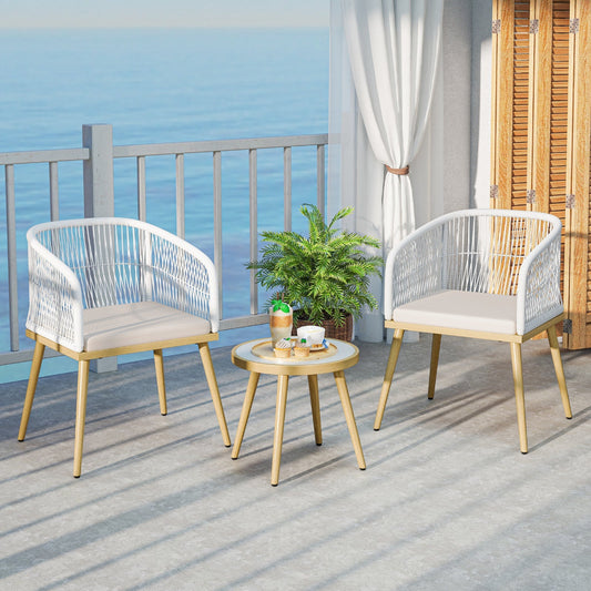 Outdoor furniture set with two chairs and a small table on a balcony with ocean view.
