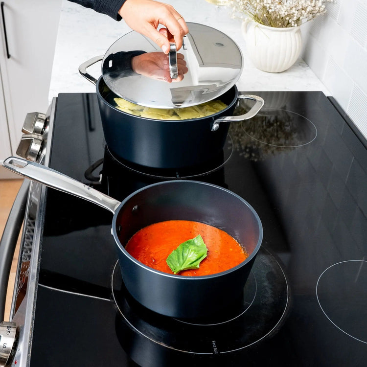 Alva Cookware 9-piece cookware set featuring pots with lids, stainless steel construction, and ergonomic handles.