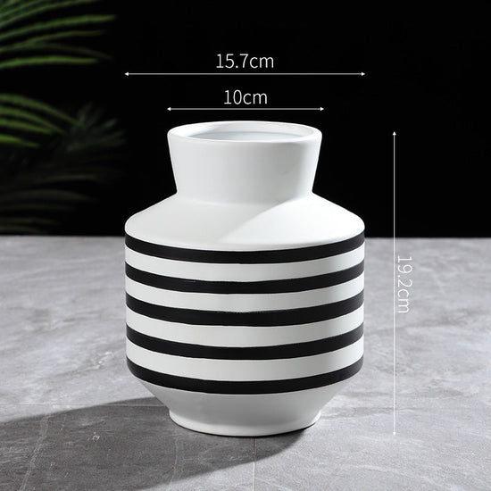 Modern black and white striped ceramic vase by FLIPSTYLEZLLC, featuring a sleek, light luxury design for contemporary home decor.