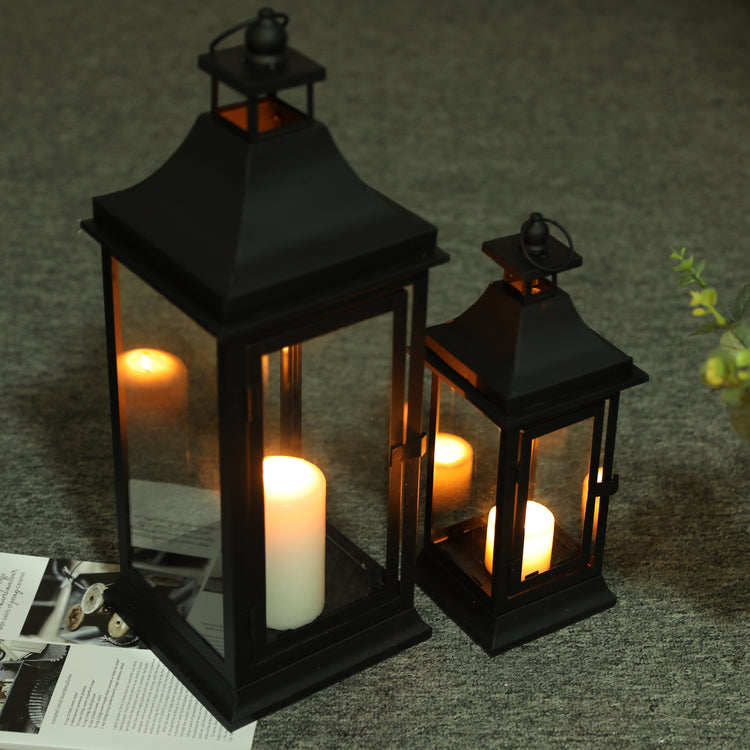 Set of two JHY DESIGN outdoor decorative candle lanterns, 13 and 19.5 inches tall with glass panels and metal frames.