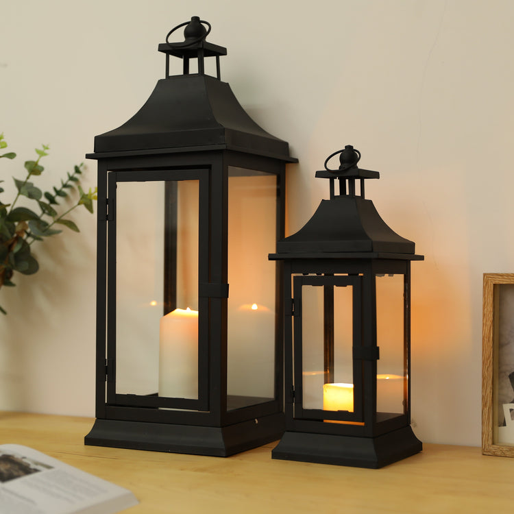 Set of two JHY DESIGN outdoor decorative candle lanterns, 13 and 19.5 inches tall with glass panels and metal frames.