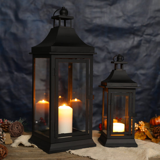 Set of two JHY DESIGN outdoor decorative candle lanterns, 13 and 19.5 inches tall with metal frames and glass panels.