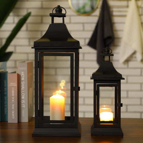 Set of two JHY DESIGN outdoor decorative candle lanterns, 13 and 19.5 inches tall, with glass panels and metal frames.