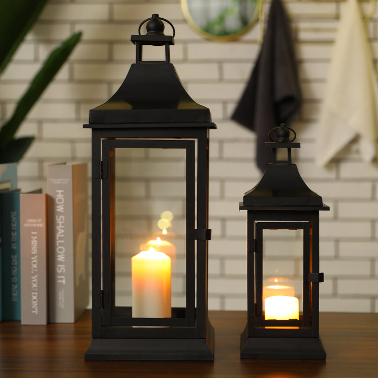 Set of two JHY DESIGN outdoor decorative candle lanterns, 13 and 19.5 inches tall, with glass panels and metal frames.
