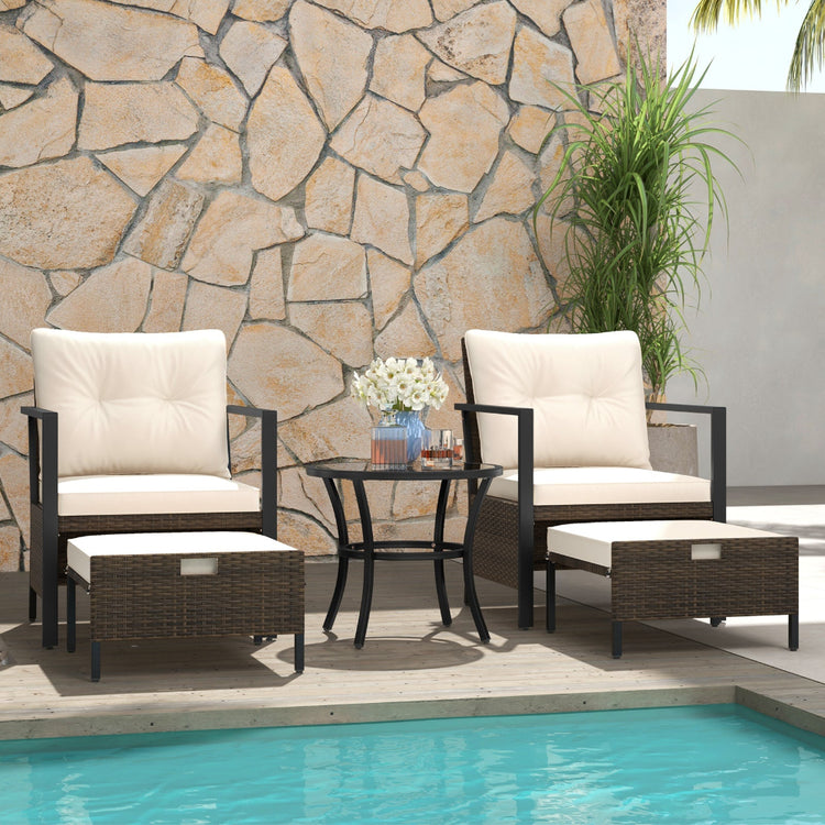 4-piece white wicker outdoor chair set with glass-topped coffee table, perfect for patio seating and outdoor relaxation.