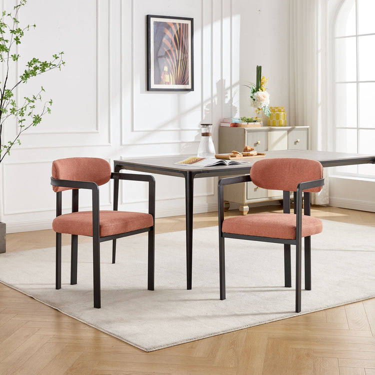 Pair of HouseOfZazla dining arm chairs with wooden legs and upholstered seats, shown in a modern dining room setting.