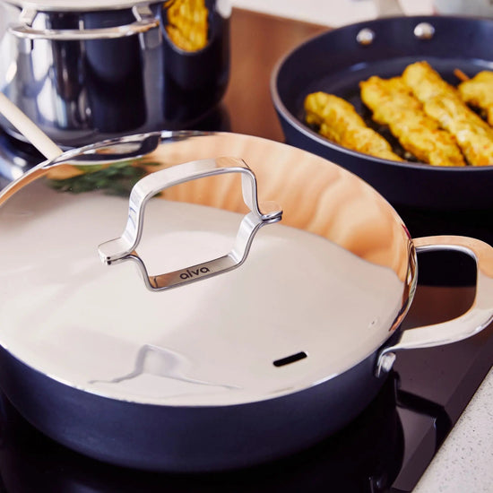 Alva Cookware 5-piece cookware set including pots and pans with stainless steel handles, suitable for various cooking tasks.