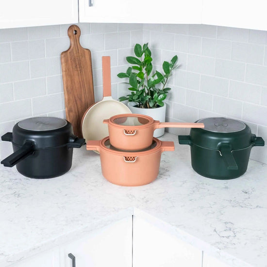 Set of five nesting cookware bowls from Alva Cookware in various sizes, stacked together for space-saving storage.
