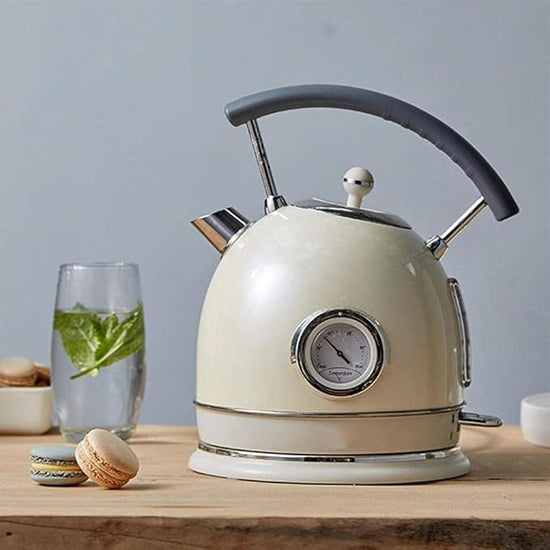 SmartPursue™ electric kettle with built-in thermometer, stainless steel body, and ergonomic handle for boiling water.