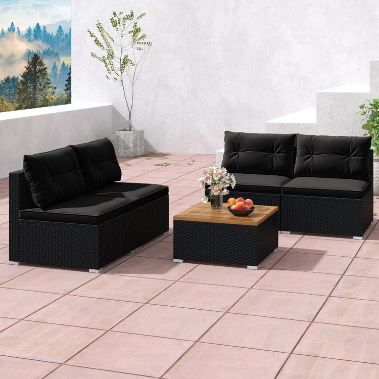 Black wicker outdoor chair set with five-piece patio seating including chairs and a table for garden or patio use.
