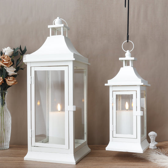 Set of two JHY DESIGN outdoor decorative candle lanterns, 19.5 and 13 inches tall, with glass panels and metal frames.