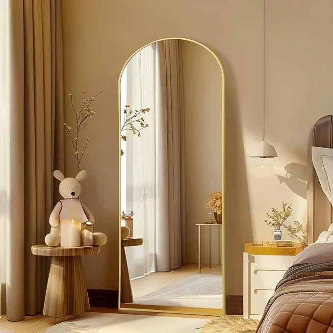 Large arched floor mirror with gold frame by MIRRORONS, full-length design for bedroom, living room, or gym use.