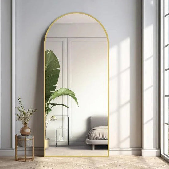 Large arched full-length mirror by MIRRORONS with a gold frame, ideal for bedroom, living room, or gym, hanging or leaning.