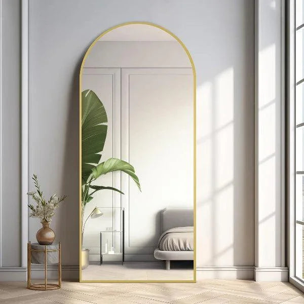 Large arched full-length mirror by MIRRORONS with a gold frame, ideal for bedroom, living room, or gym, hanging or leaning.