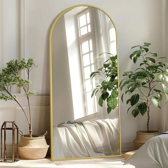 Large arched gold frame full-length mirror by MIRRORONS, floor or leaning mirror for bedroom, living room, or gym.