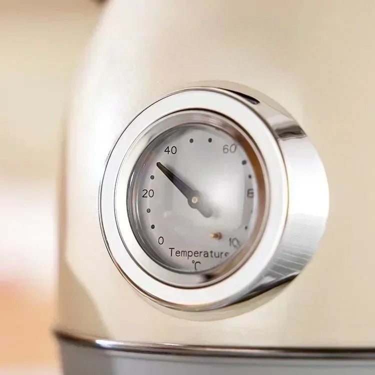 SmartPursue™ electric kettle with built-in thermometer, stainless steel body, and clear water level indicator.