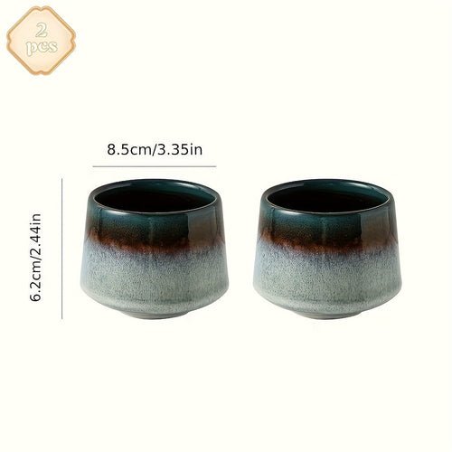 Two ceramic cups with gradient design and measurements on a white background
