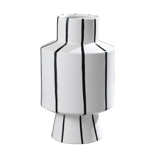 Black and white striped ceramic vase with a sleek, modern design, perfect for contemporary home decor.