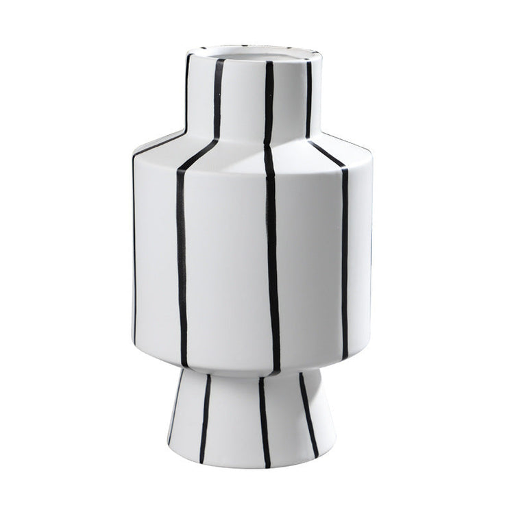 Black and white striped ceramic vase with a sleek, modern design, perfect for contemporary home decor.