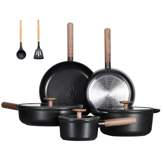 Set of black cookware with wooden handles on a white background